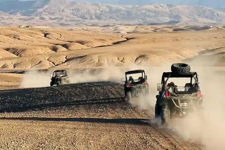 Group of luxury buggies driving through the Agafay Desert near Marrakech with panoramic mountain views