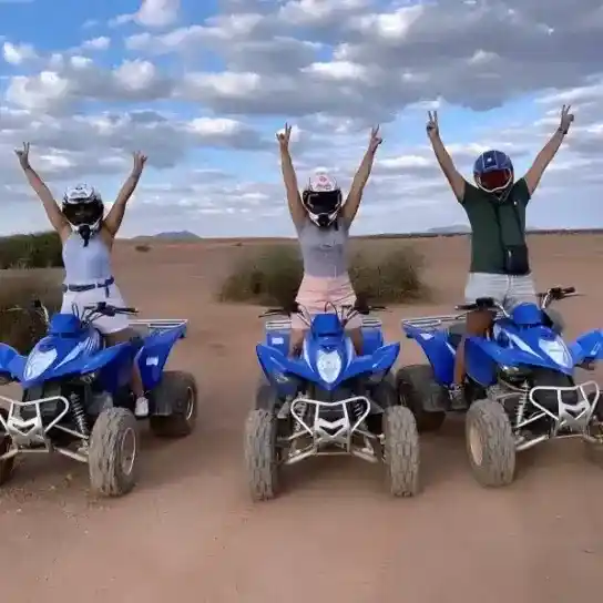 Tourists celebrating during a quad biking adventure in the Agafay Desert near Marrakech