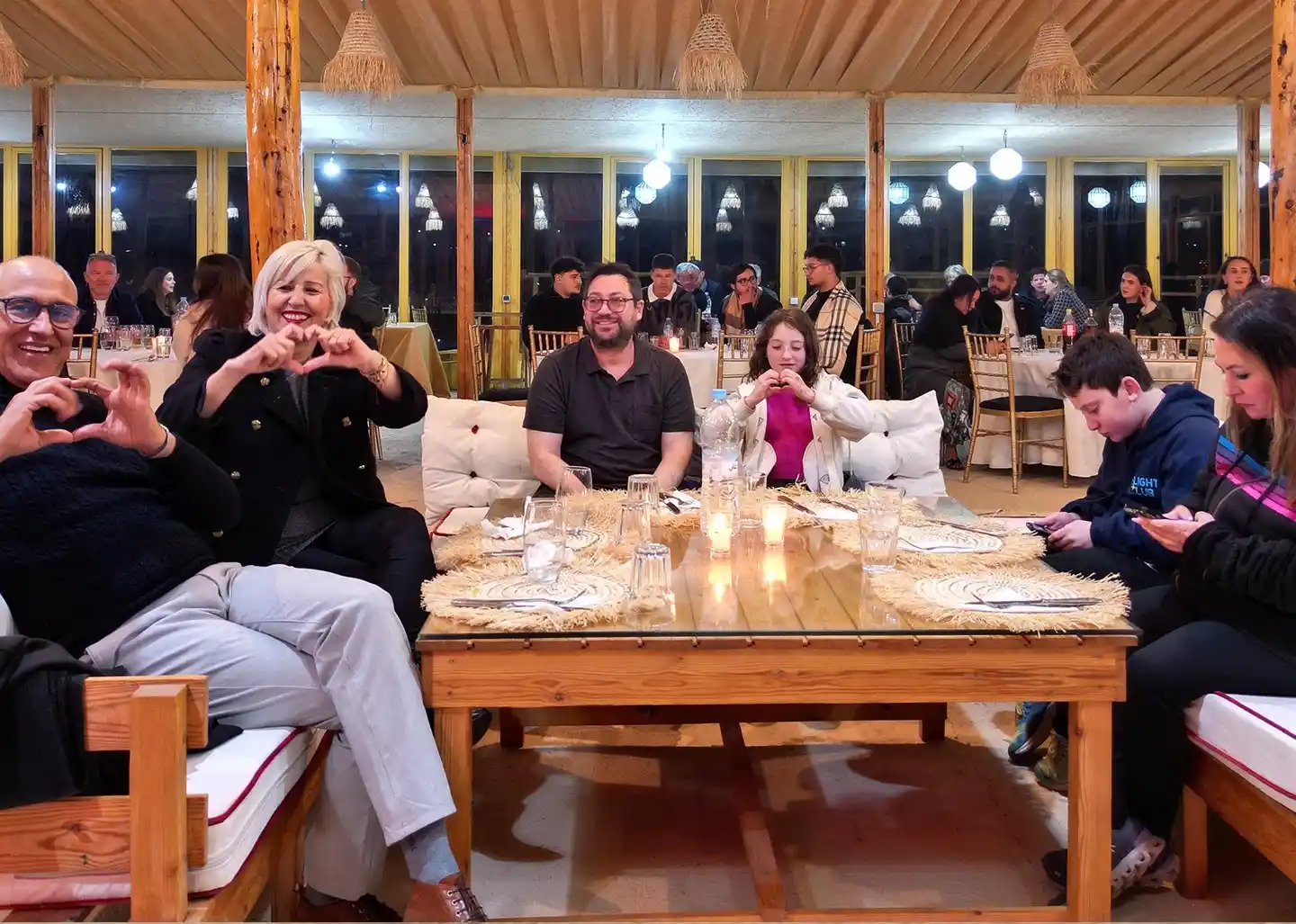 Guests enjoying a luxury dinner show experience in an exclusive Agafay Desert camp near Marrakech