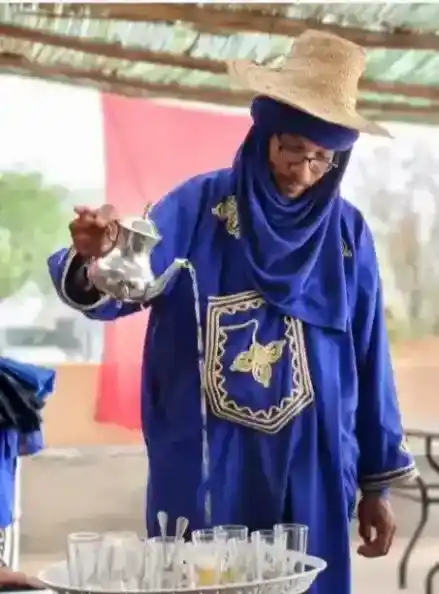 Berber host serving traditional Moroccan tea during a quad bike tour in Marrakech Palmeraie