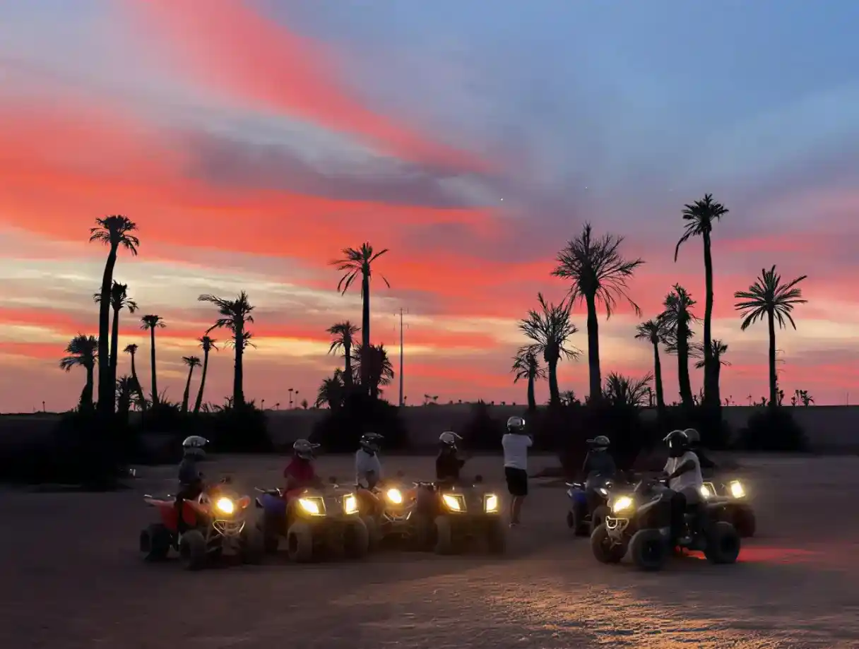 Group quad biking adventure in Marrakech at sunset with colorful desert skies