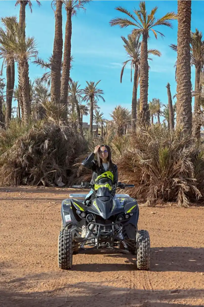 Woman posing on a quad bike during a Marrakech Palmeraie adventure tour