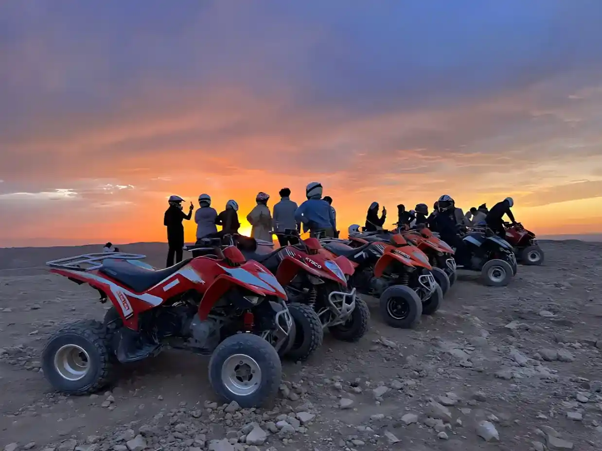 Group of quad bikes parked in the Agafay Desert during a sunset tour near Marrakech