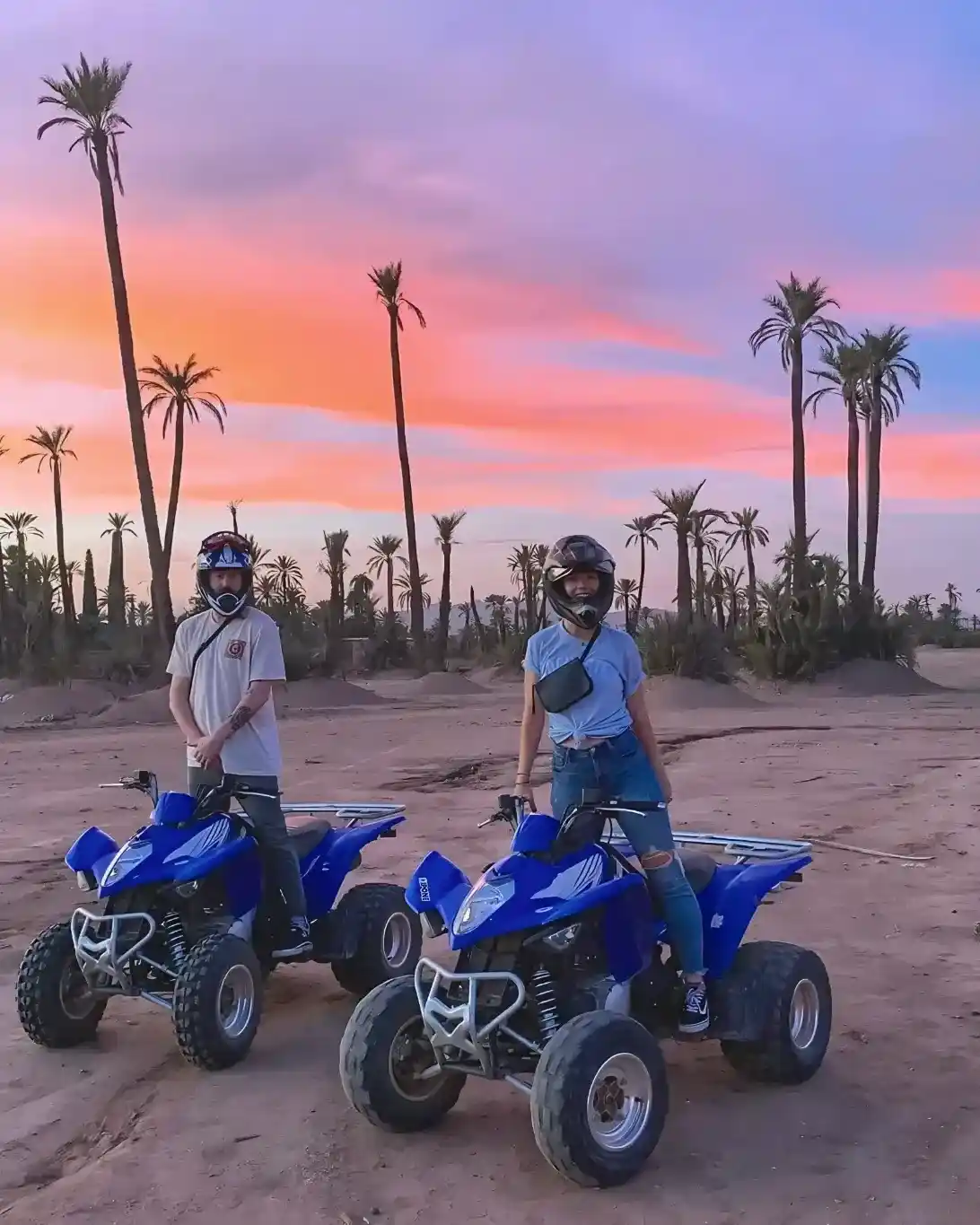 Tourists on quad bikes during an evening sunset tour through Marrakech Palmeraie.