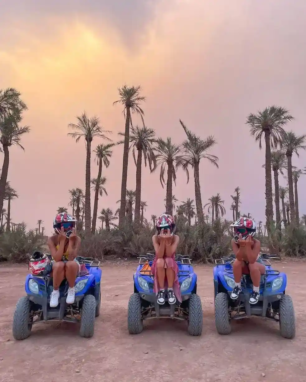 Visitors posing on quad bikes during a guided quad biking tour in the Palmeraie of Marrakech